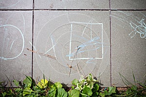 Chalk drawings on park ceramic tiles.