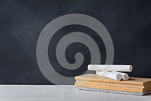 Chalk and eraser board on the white desk. Blackboard background