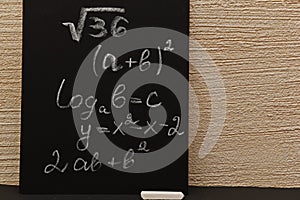 Chalk image on the blackboard of mathematical formulas for solving problems and equations of varying degrees of complexity