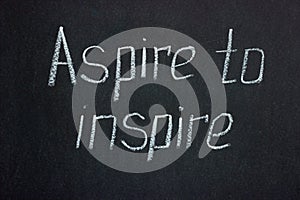 Chalk lettering on dark board Aspire to inspire photo