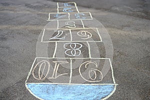 Chalk-painted hopscotch on asphalt