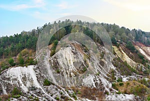 Chalk structure on artificial mountain after quarry mining. Technogenic rock formed during mine. Mountain hill with chalk fossil