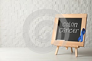 Chalkboard with blue ribbon and text Colon cancer awareness photo