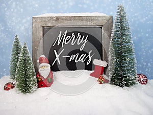 Chalkboard with christmas decoration with snow and snowflakes with message Merry X-Mas