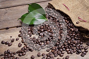 Chalkboard with coffee beans and a cup of coffee on natural brown wood