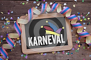 Chalkboard with the german word for carnival - Karneval on wooden background