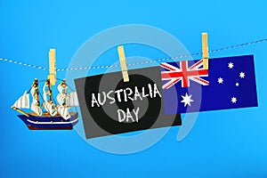 Chalkboard with the inscription: Happy day of Australia surrounded by shipwrights, a compass, a clock and an Australian flag on a