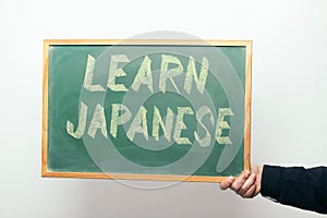 Chalkboard with LEARN JAPANESE written in chalk