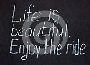 Chalkboard lettering `Life is beautiful. Enjoy the ride`