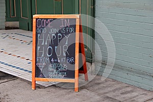 Chalkboard menu inviting folks in for happy hour