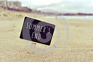 Chalkboard with the text summers end in a beach