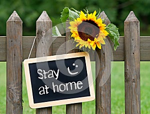 Chalkboard with text and sunflower, stay at home