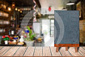 Chalkboard wood frame blackboard sign menu on wooden table, Blurred image background.