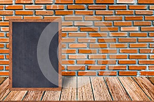 Chalkboard wood frame, blackboard sign menu on wooden table and brick wall background.