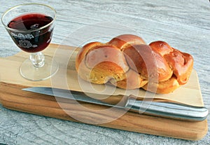 Challah bread wine in glass on board