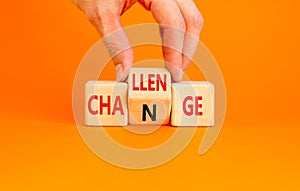 Challenge and change symbol. Concept word Challenge Change on wooden cubes. Businessman hand. Beautiful orange table orange