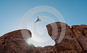 Challenge, risk and freedom concept. Silhouette a man jumping over precipice crossing cliff