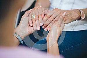 A challenge shared. a two unrecognizable people holding hands in support of one another.