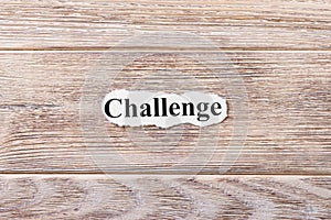 Challenge of the word on paper. concept. Words of Challenge on a wooden background