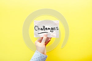 Challenges - card in hand with text about motivation on yellow background