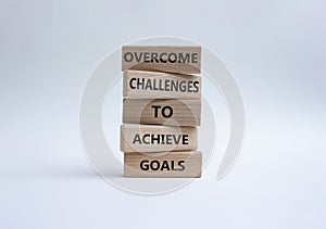 Challenges or goals symbol. Wooden blocks with words Overcome challenges to achieve goals. Beautiful orange background. Busine
