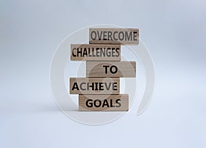 Challenges or goals symbol. Wooden blocks with words Overcome challenges to achieve goals. Beautiful white background. Busines