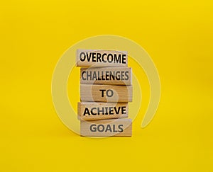Challenges or goals symbol. Wooden blocks with words Overcome challenges to achieve goals. Beautiful yellow background. Busine