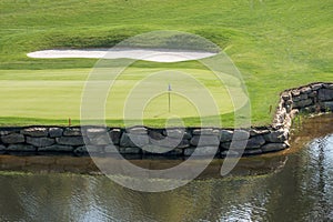 Challenging hole on luxury golf course with water and sand