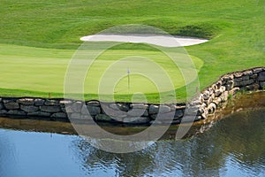 Challenging hole on luxury golf course with water and sand