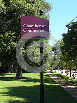 Chamber of Commerce Signpost along Tree-Lined Sidewalk
