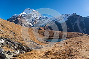 Chamlang mountain peak behind small alpine lake a long the way to Amphulapcha high mountain pass, Everest region, Himalaya photo