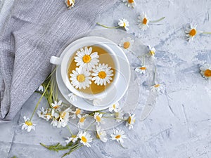 Chamomile flower tea on concrete background herbal