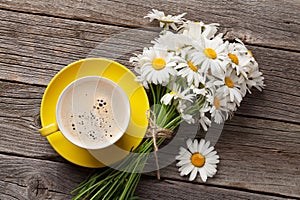 Chamomile flowers bouquet and coffee cup