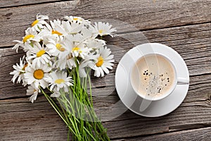 Chamomile flowers bouquet and coffee cup