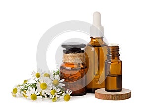 Chamomile flowers and essential oil for herbal alternative medicine and massage isolated on white background