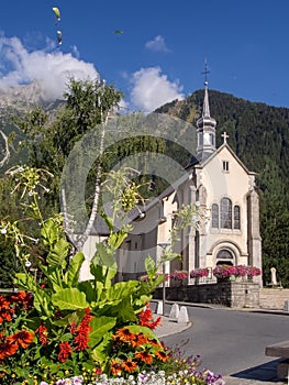 Chamonix Mont Blanc, Haute Savoie region, France. View of the square with catholic church of St Michel in summer with