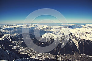 Chamonix valley panoramic aerial view from Aiguille du Midi mountain peak. Popular touristic destination.