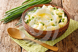 Champ is an Irish dish Mashed potatoes with green onions close up in the bowl. Horizontal