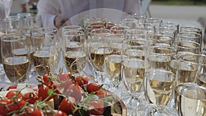 Champagne with appetizers on the buffet table. Buffet table, canape with cheese, cherry tomato and olive. Snacks and