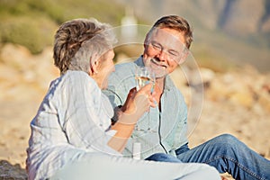 Champagne, beach and love celebration of mature couple with care and support of marriage. Toast, wine and sea picnic of