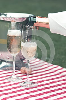 Champagne being poured at a summer picnic