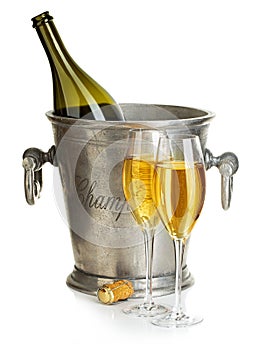 Champagne bottle with bucket ice and glasses of champagne, isolated on white. Festive still life.