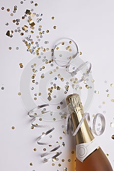 champagne bottle with confetti ready for the new year