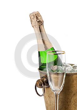 Champagne bottle in cooler and glass