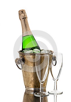 Champagne bottle in cooler and two champagne glasses