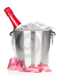 Champagne bottle in ice bucket and christmas decor