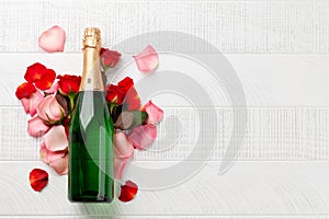 Champagne bottle and rose flowers