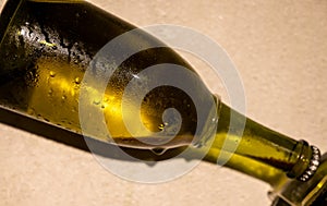 Champagne bottle during second fermentation with lees or dead yeast cells, making champagne sparkling wine from chardonnay and