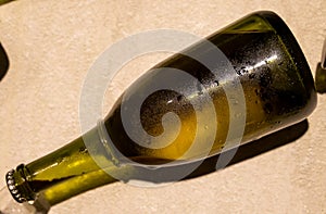 Champagne bottle during second fermentation with lees or dead yeast cells, making champagne sparkling wine from chardonnay and