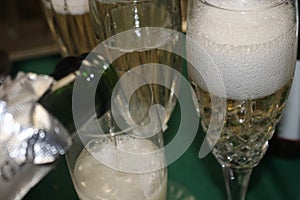 Champagne bubbles in a crystal glass wth more champagne being poured
